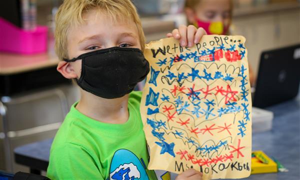 Boy holds up US Constitution craft